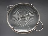 an antique silver plate with a starburst design on it