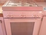 a white stove top oven sitting in the middle of a kitchen
