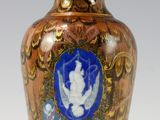 a brown vase with a blue and white picture on it