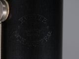 close up of a metal object with a black background and a silver handle