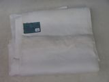 a piece of white cloth with a green tag on it