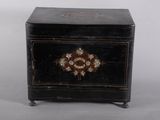 a small black box with a decorative decoration on it