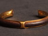 a close up of a bracelet on a black surface