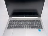 an open laptop computer sitting on top of a white table