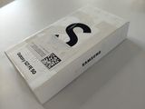 a white box on a table with a black logo on it