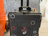 a piece of luggage sitting on the floor next to an orange suitcase