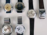 a lot of watches that are sitting on a table