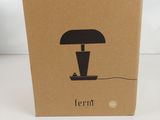 a brown box with a black lamp on top of it