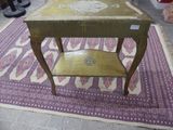 a small wooden table on a rug on the floor
