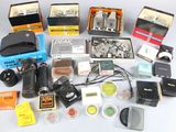 many different types of cameras and accessories laid out on a table