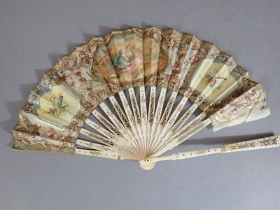a fan with a design on it on a table