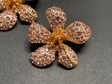 a close up of a flower brooch on a table
