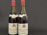 two bottles of wine sitting next to each other on a table