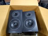 two speakers sitting in a box on top of a table