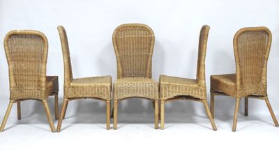 four wicker chairs are lined up against a white backdrop