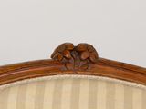 an image of a close up of a chair with a striped upholstered back