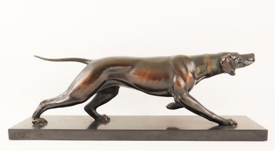 bronze statue of a dog on a marble base on a white background
