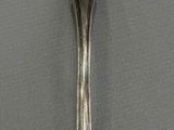 a silver fork and a spoon on a table
