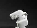 two white ceramic sculptures of a man and a woman on a black background