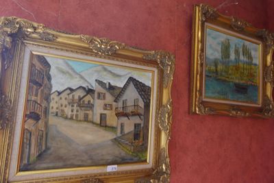 painting on the wall of a room with paintings hanging on the wall