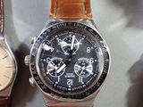 two watches are sitting next to each other on a table