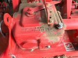 a red machine that is sitting on the ground