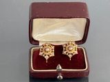 a small box with two pairs of earrings in it