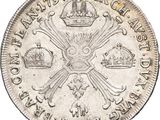 a close up of a silver coin with a crown on it