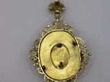 a gold locke with a picture of a woman in the center