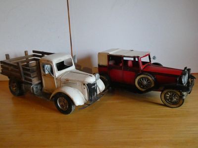 two toy cars that are sitting on a table