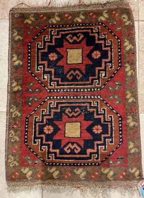 an old rug with two different colors and designs on it