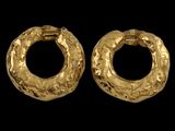 a pair of gold hoop earrings