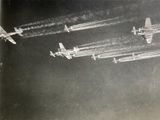 several airplanes flying in formation in the sky with smoke coming out of them
