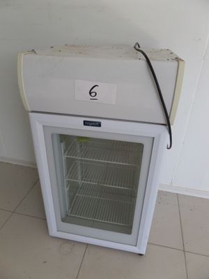 a white refrigerator with a glass door in a room