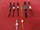 a lot of watches that are sitting on a red surface