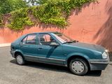 a blue car that is parked on the side of the road