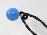a blue ball and a black plastic object on a white surface