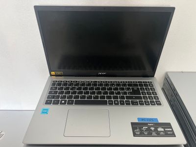 a laptop computer sitting on top of a stack of books
