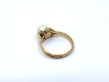 an image of a gold ring with a pearl and a diamond