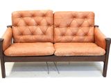 a brown leather couch that is sitting on a white floor