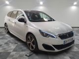 the white car is parked on a checkered floor in the garage