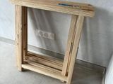 a small wooden table with a glass shelf on it