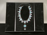 an image of a necklace and earrings in a box on a table