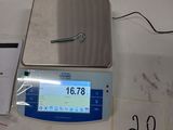 an image of a scale on a table with a pen on it