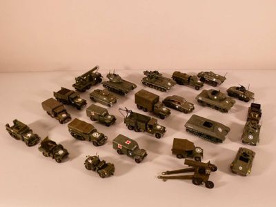 a lot of toy army vehicles on a white surface