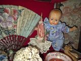 a doll that is sitting on a table with a fan