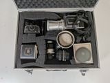 a silver case with a camera and other items in it