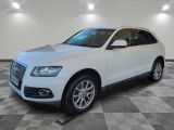 the white audi suv is parked on a checkered tile floor