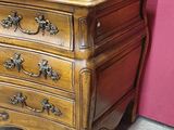 a wooden chest of drawers with ornate carvings on the drawers