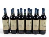 six bottles of wine are lined up in a row on a white surface